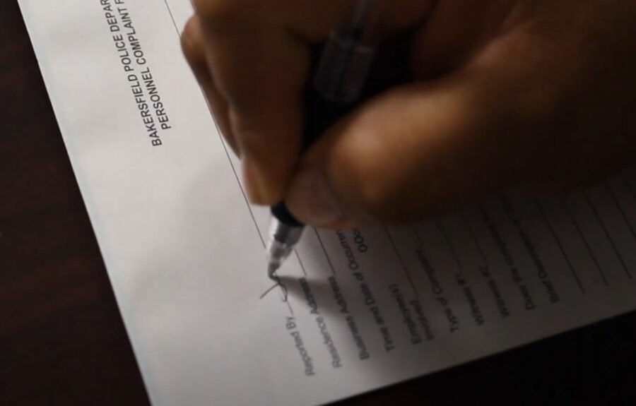 Hand writing a report on a paper