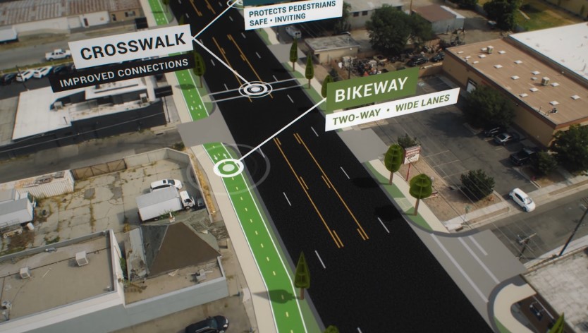 A street featuring a green line and a green arrow indicating direction