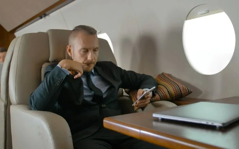 Businessman engrossed in work on a private jet