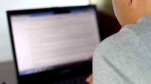 Person using a laptop to search how to unblock a website