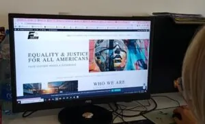 Woman looking at Freedom for All Americans website on a PC