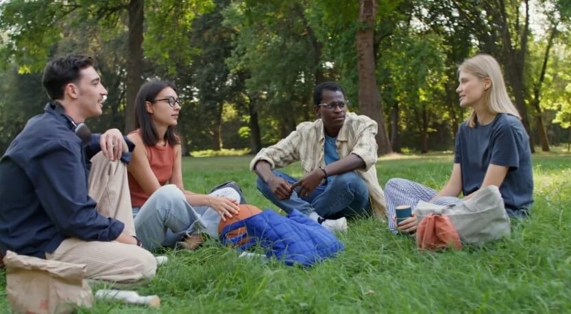 Students seating on grass in campus