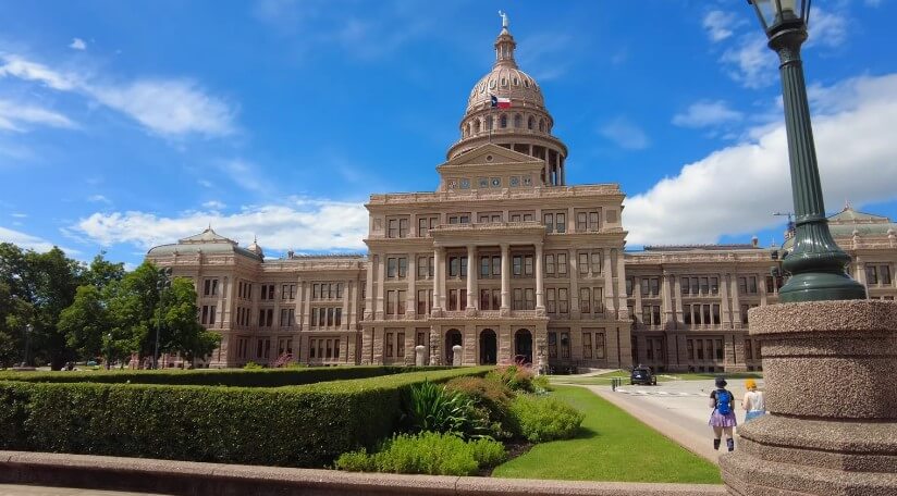 Texas State Capitol building under a bright blue sky