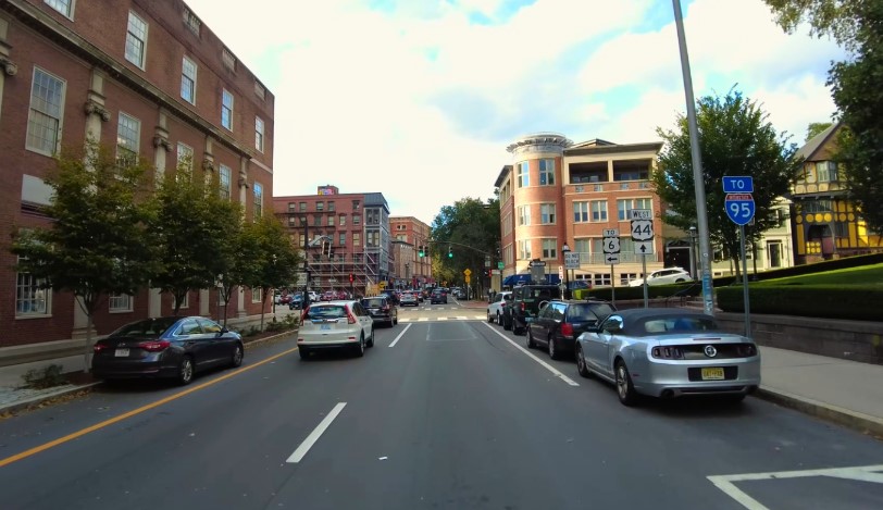 Street view with cars and buildings on a sunny day