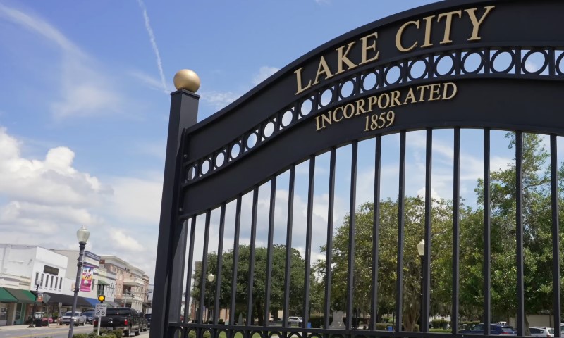 Entrance gate marking "Lake City Incorporated 1859" on a bright, sunny day
