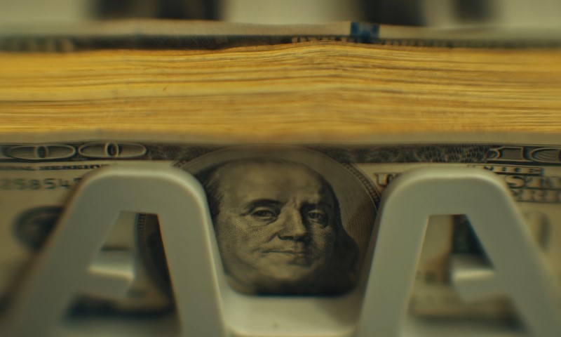 Close up photo of dollar bils in money counter machine
