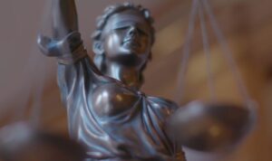 A statue of Justice holding a balanced scale