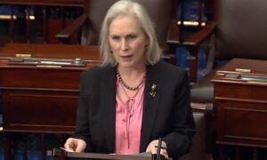 Senator Gillibrand in a suit speaks confidently at a desk