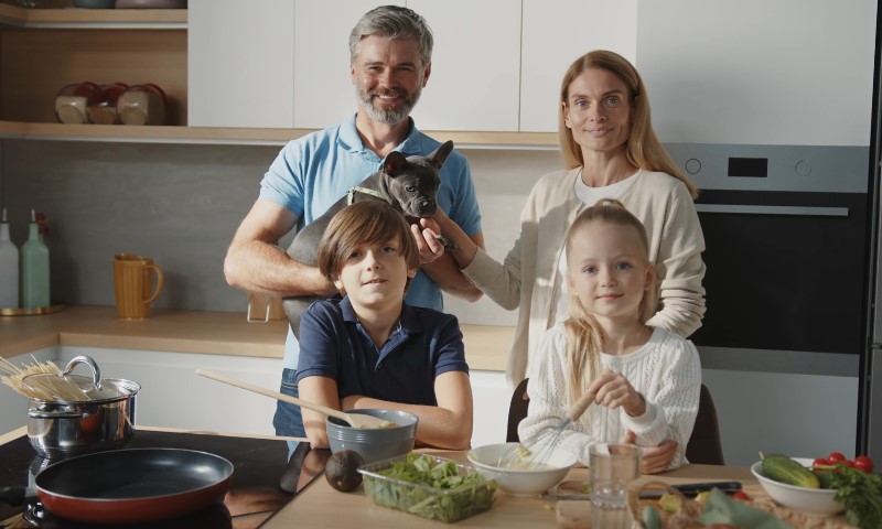 Happy family standing in the kitchen