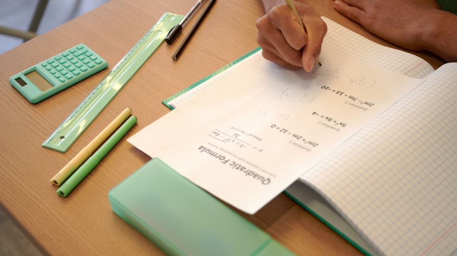 A student solving math problems during a study session