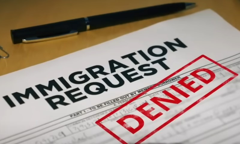 Text stating "Immigration Denied" prominently displayed on a document or notice