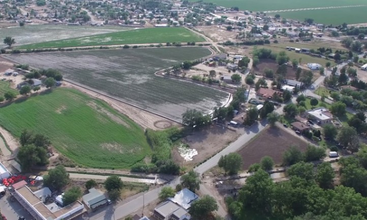 Aerial view of San Elizario, showcasing a farm and town surrounded by expansive fields