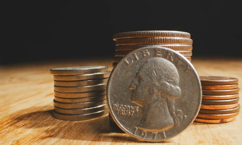A stack of coins topped with a coin head