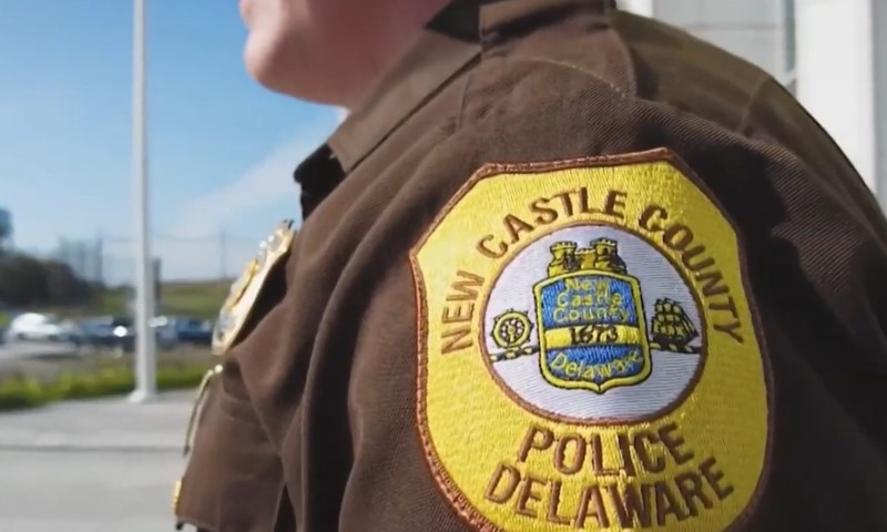 New Castle County police officer and a close up on a police badge on officer's sleeve