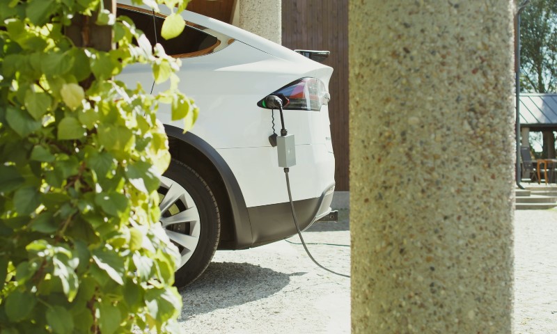 White electric car charging at home