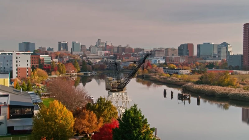 A city skyline in Delaware along a river, representing the state as a legal home for new businesses
