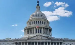 U.S. Capitol building with its iconic dome and American flag, set against a clear blue sky