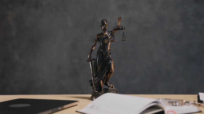 Statue of justice on a desk, representing appeal rights under Public Act 52