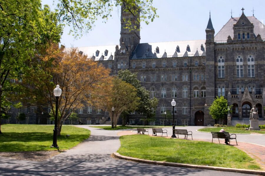 Historic university campus with academic buildings, green lawns, and walking paths