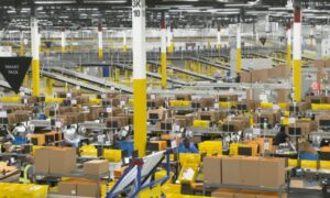 Busy Amazon warehouse interior. Workers organize boxes conveying efficiency.