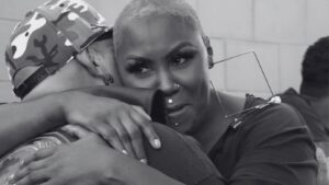 Black and white photo of two people embracing warmly