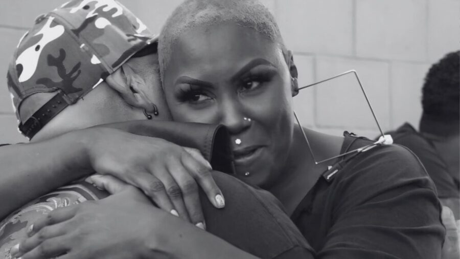 Black and white photo of two people embracing warmly