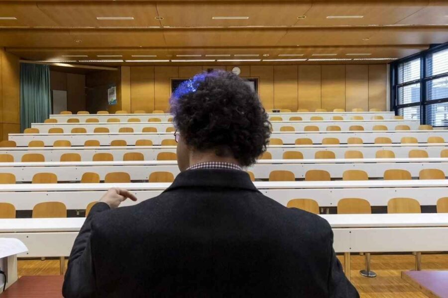University lecture hall viewed from behind a faculty member, representing federal compliance obligations in higher education for 2026.