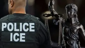 ICE officer seen from behind next to a statue of Lady Justice, representing legal accountability for use of force