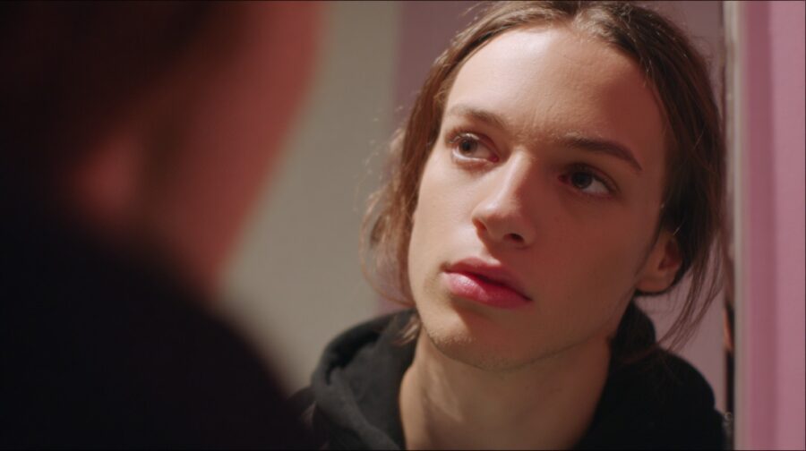 Close up of a young person listening intently to someone off camera indoors