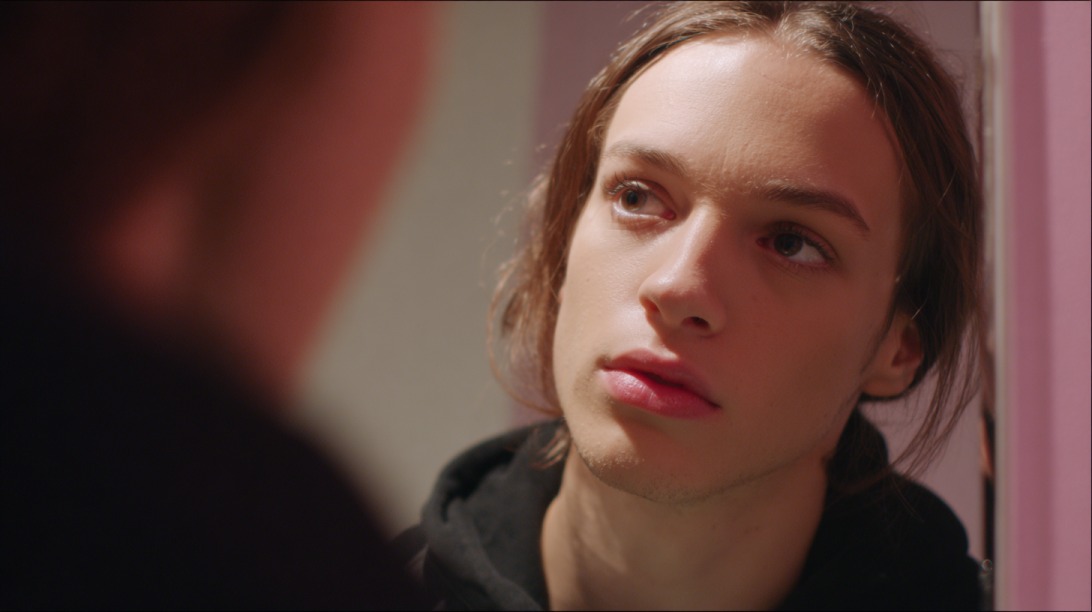 Close up of a young person listening intently to someone off camera indoors