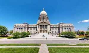 Majestic neoclassical capitol building against a clear blue sky, featuring a grand dome