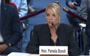 Hon. Pamela Bondi speaking at a formal hearing,