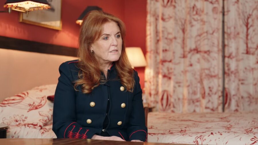 Sarah Ferguson sits in a room with red and white decor