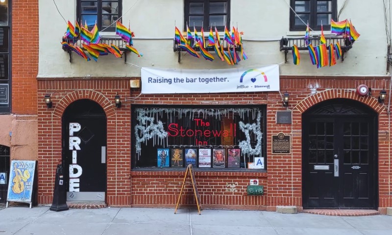 Stonewall Inn facade with rainbow flags