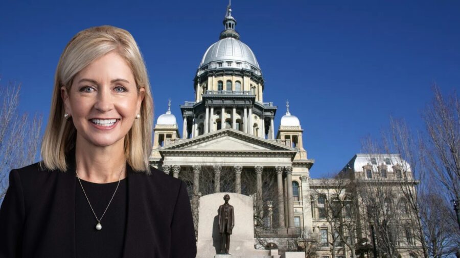 Mary E. Miller standing confidently before the Illinois State Capitol building under a clear blue sky
