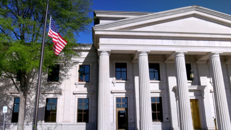Federal courthouse with U.S. flag outside, representing government substitution in a civil case