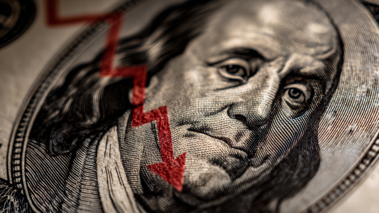 Close-up of Benjamin Franklin on a dollar bill with a red downward arrow illustrating why are all markets crashing