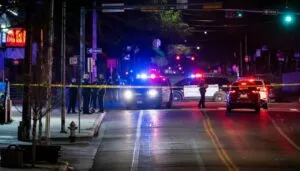 Police cars parked at a dimly lit intersection at night