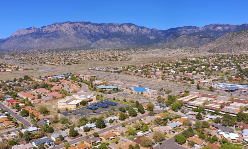 Aerial view of a suburban area with houses and buildings scattered across a desert landscape