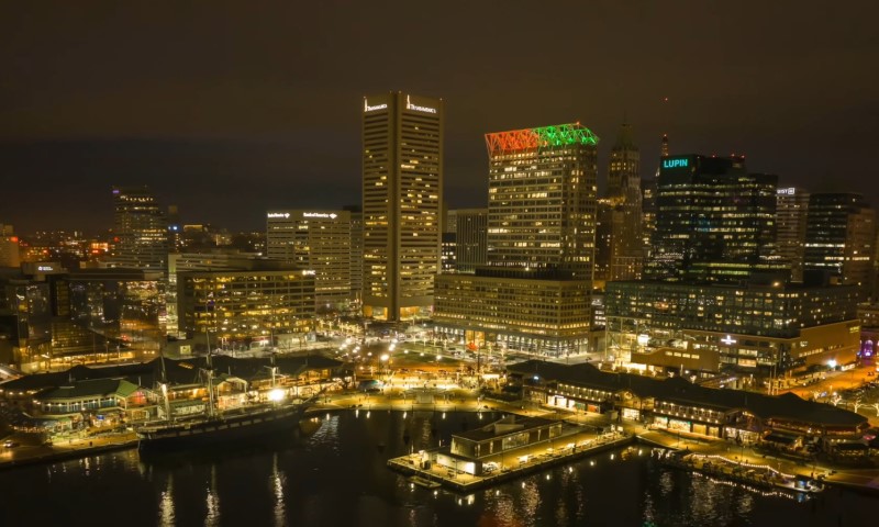Nighttime cityscape of Baltimore's Inner Harbor