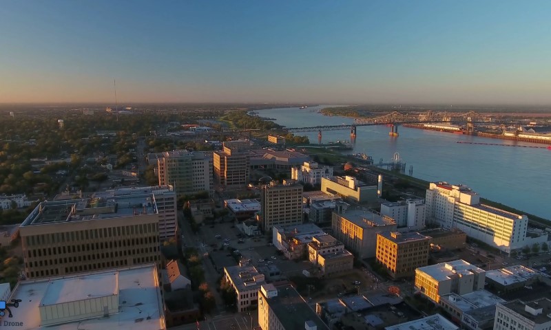 Aerial view of Baton Rouge at sunset with a river to the right