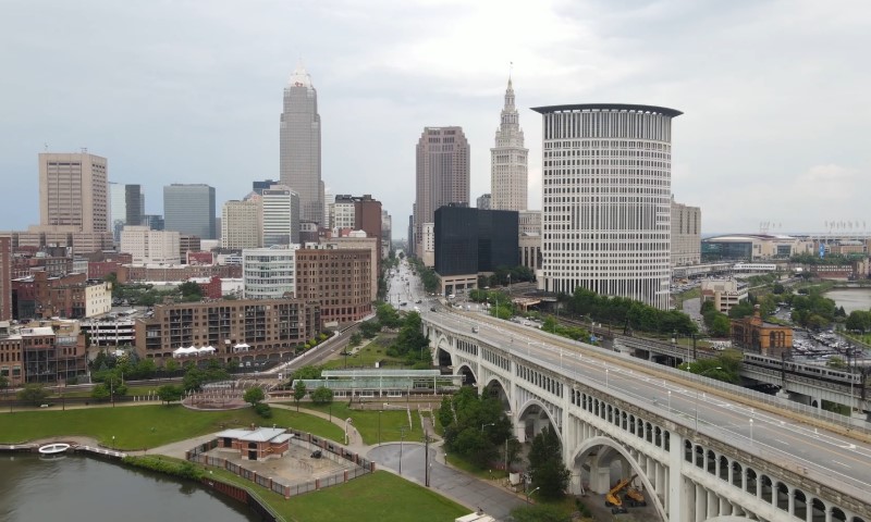 Aerial view of a Cleveland featuring tall buildings under a cloudy sky.