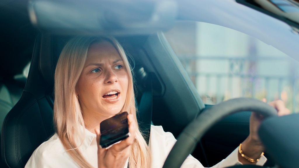 Driver using phone while driving, distracted behavior inside car