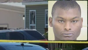 Shamar Elkins mugshot shown beside a house with police tape after a Louisiana mass shooting scene