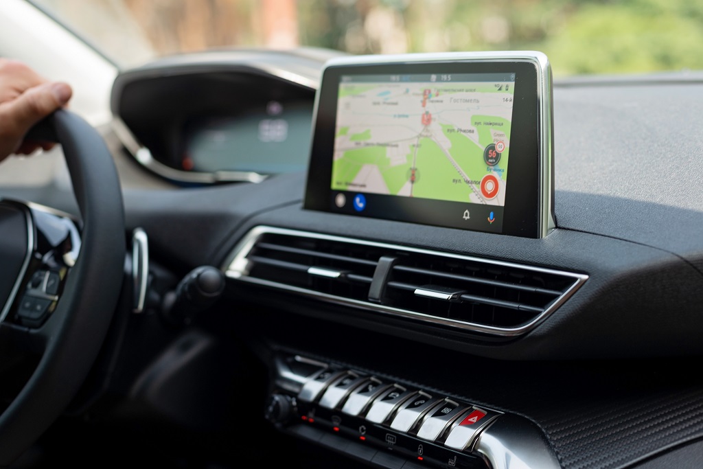 Vehicle dashboard display showing navigation system during driving