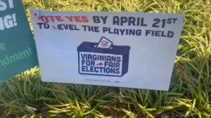 Campaign sign about Virginia election with “Vote Yes by April 21st” message on a lawn