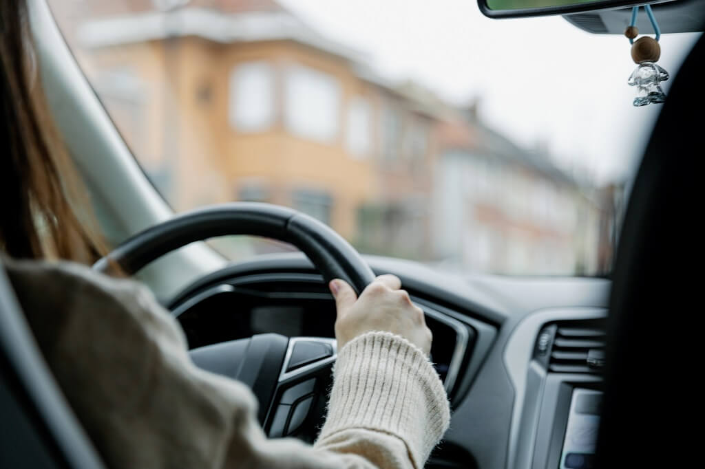 Driver focused on road while driving through urban neighborhood