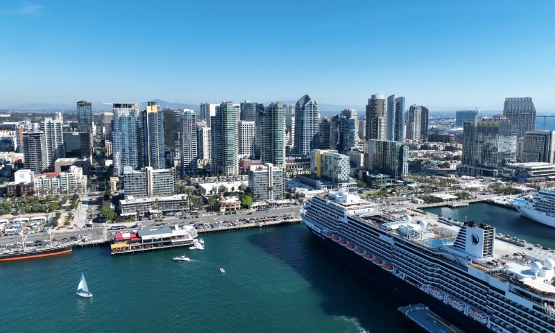 Aerial view of a bustling harbor of San Diego, with a large cruise ship docked