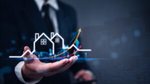 Real estate growth chart above a businessperson’s hand