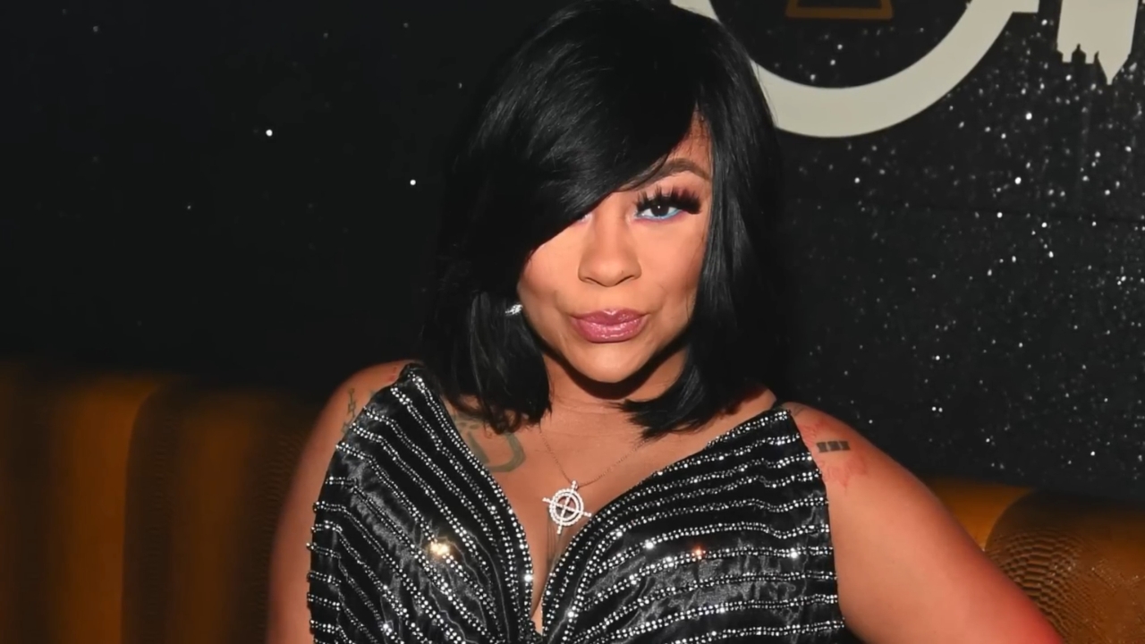 Nivea poses in a black sequined dress at an event